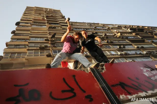 Egyptian protesters dismantle the concrete wall which was built in front of the Israeli embassy, in Cairo, Egypt, 09 September 2011. Security forces had built the wall in an attempt to secure the embassy after a series o...