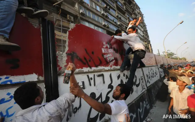 Egyptian protesters dismantle the concrete wall which was built in front of the Israeli embassy, in Cairo, Egypt, 09 September 2011. Security forces had built the wall in an attempt to secure the embassy after a series o...