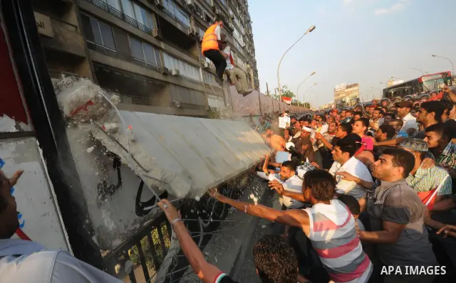 Egyptian protesters dismantle the concrete wall which was built in front of the Israeli embassy, in Cairo, Egypt, 09 September 2011. Security forces had built the wall in an attempt to secure the embassy after a series o...