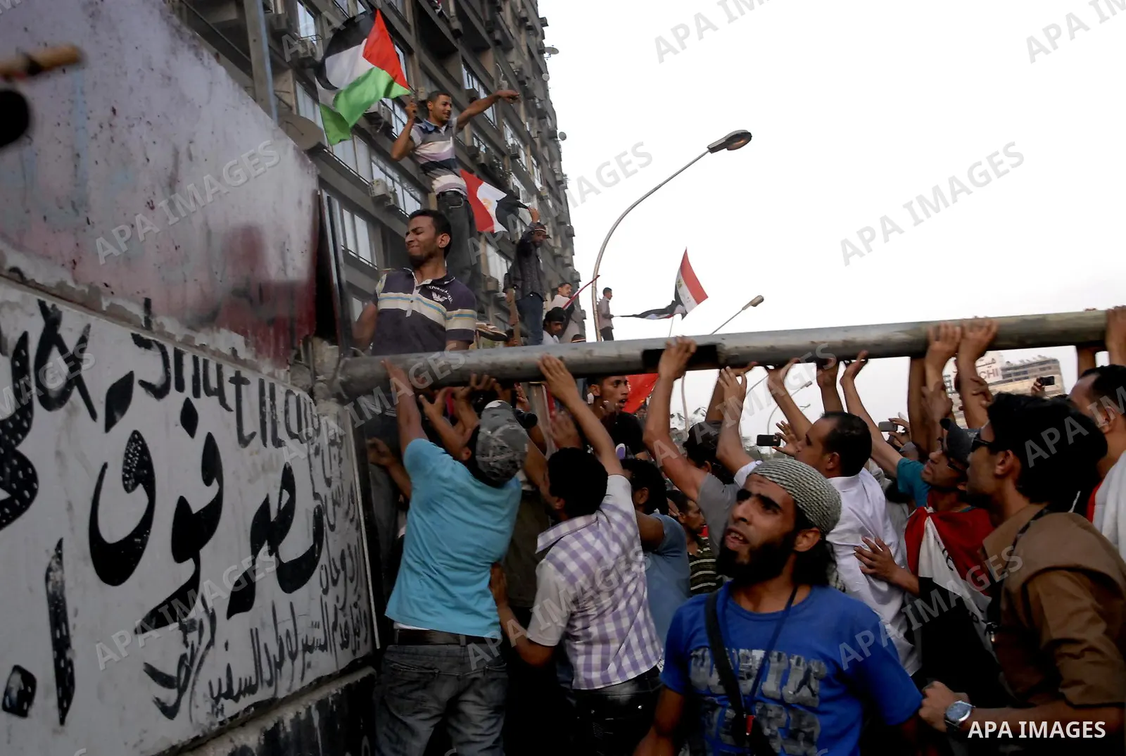 Egyptian protesters dismantle the concrete wall which was built in front of the Israeli embassy, in Cairo, Egypt, 09 September 2011. Security forces had built the wall in an attempt to secure the embassy after a series o...