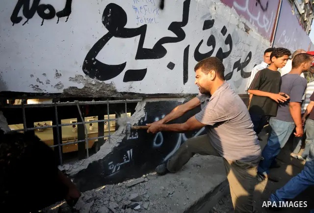 Egyptian protesters dismantle the concrete wall which was built in front of the Israeli embassy, in Cairo, Egypt, 09 September 2011. Security forces had built the wall in an attempt to secure the embassy after a series o...