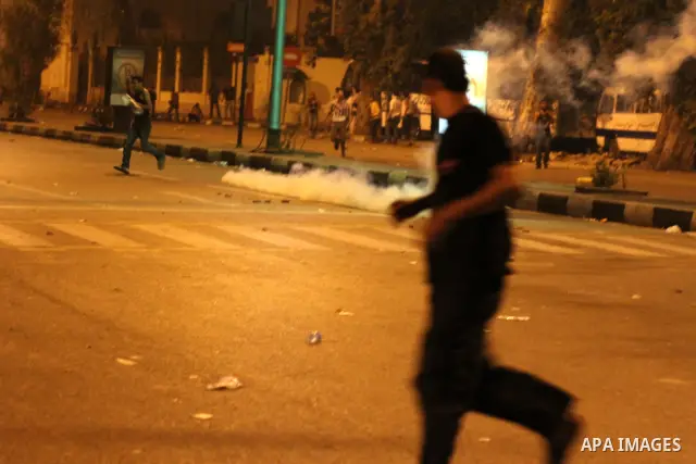 Egyptian demonstrators throw stones at police early on September 10, 2011 during clashes outside the Israeli embassy in Cairo after protesters raided the building. Photo by Ahmed Asad