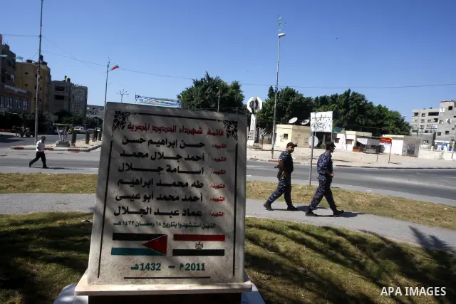 Palestinian policemen walk near the memorial site in memory of the Egyptian policemen who were killed by the Israeli army in Gaza city on Sep.10, 2011. While the Egyptians held a series of protests in front of the Israel...
