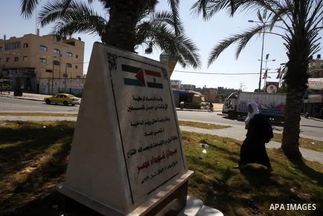 A Palestinian girl walks near the memorial site in memory of the Egyptian policemen who were killed by the Israeli army in Gaza city on Sep.10, 2011. While the Egyptians held a series of protests in front of the Israeli...