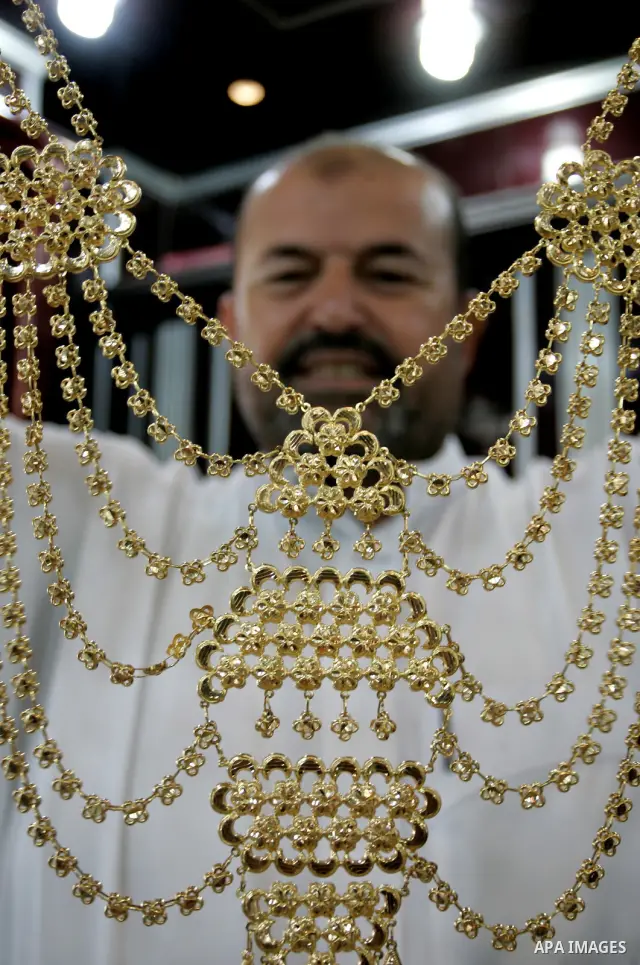 A Palestinian vendor displays a gold jewellery at a jewellery store in the Rafah Refugee Camp, Southern Gaza Strip on Sep. 10, 2011. Decline in demand for gold in the Palestinian markets due to the high price of $ 50 per...