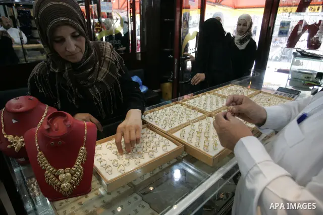 Palestinian women look at gold jewellery at a jewellery store in the Rafah Refugee Camp, Southern Gaza Strip on Sep. 10, 2011. Decline in demand for gold in the Palestinian markets due to the high price of $ 50 per gram,...