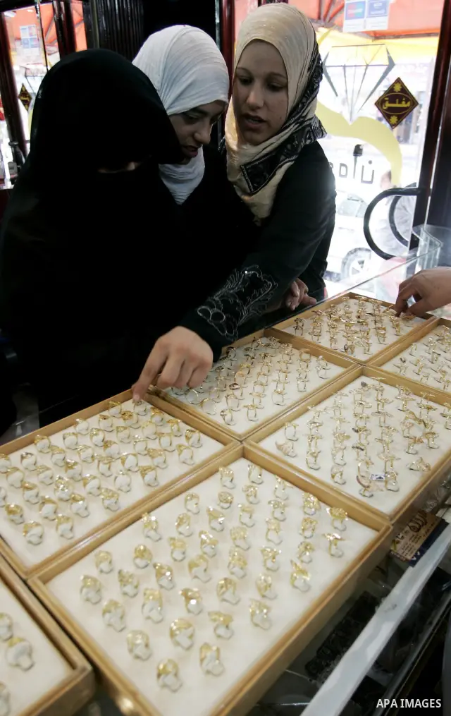 Palestinian women look at gold jewellery at a jewellery store in the Rafah Refugee Camp, Southern Gaza Strip on Sep. 10, 2011. Decline in demand for gold in the Palestinian markets due to the high price of $ 50 per gram,...