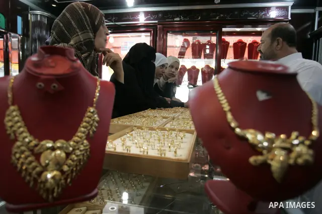 Palestinian women look at gold jewellery at a jewellery store in the Rafah Refugee Camp, Southern Gaza Strip on Sep. 10, 2011. Decline in demand for gold in the Palestinian markets due to the high price of $ 50 per gram,...
