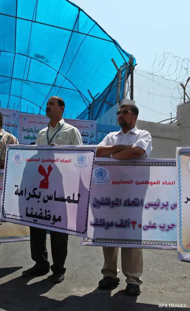 Palestinians take part in a protest against the decision to stop the head of the Federation of staff, Suhail al-Hindi to work temporarily, infront of the UNRWA headquarters in Gaza city on Sep. 11, 2011. Union officials...
