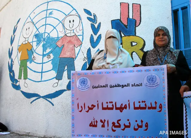 Palestinians take part in a protest against the decision to stop the head of the Federation of staff, Suhail al-Hindi to work temporarily, infront of the UNRWA headquarters in Gaza city on Sep. 11, 2011. Union officials...