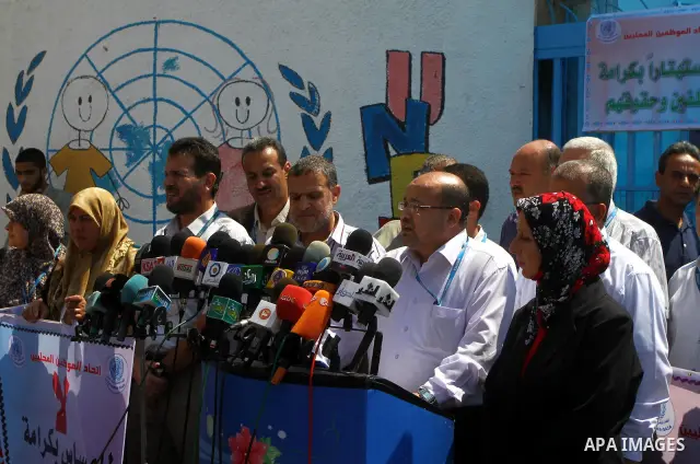 Palestinians deliver speech during a protest against the decision to stop the head of the Federation of staff, Suhail al-Hindi to work temporarily, infront of the UNRWA headquarters in Gaza city on Sep. 11, 2011. Union o...
