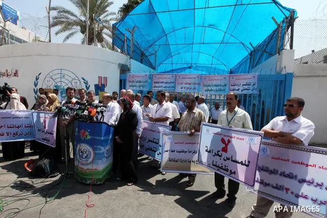 Palestinians take part in a protest against the decision to stop the head of the Federation of staff, Suhail al-Hindi to work temporarily, infront of the UNRWA headquarters in Gaza city on Sep. 11, 2011. Union officials...
