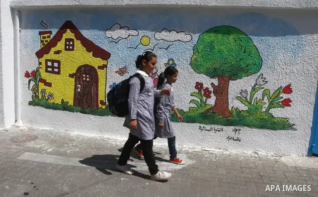 Palestinian students walk in the schools of Relief and Works Agency refugees "UNRWA", studying at the "containers" made of tin because of overcrowding and the inability to accommodate large numbers of students in Gaza ci...