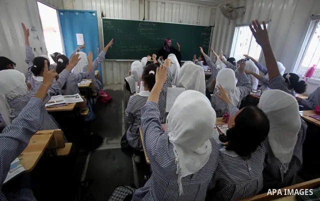 Palestinian students crammed in the schools of Relief and Works Agency refugees "UNRWA" studying at the "containers" made of tin because of overcrowding and the inability to accommodate large numbers of students in Gaza...