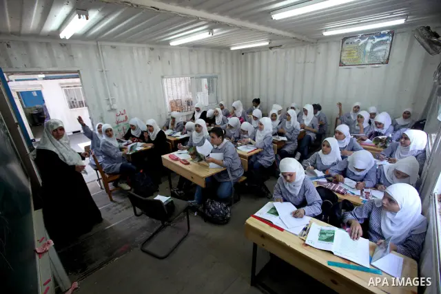 Palestinian students crammed in the schools of Relief and Works Agency refugees "UNRWA" studying at the "containers" made of tin because of overcrowding and the inability to accommodate large numbers of students in Gaza...