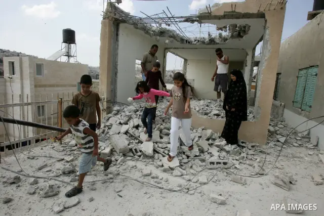 Palestinian Jerusalem resident Adnan Taha destroys his own home with a fellow Palestinian in Arab east Jerusalem on September 11, 2011, in implementation of an Israeli court order which ruled that the house was built wit...