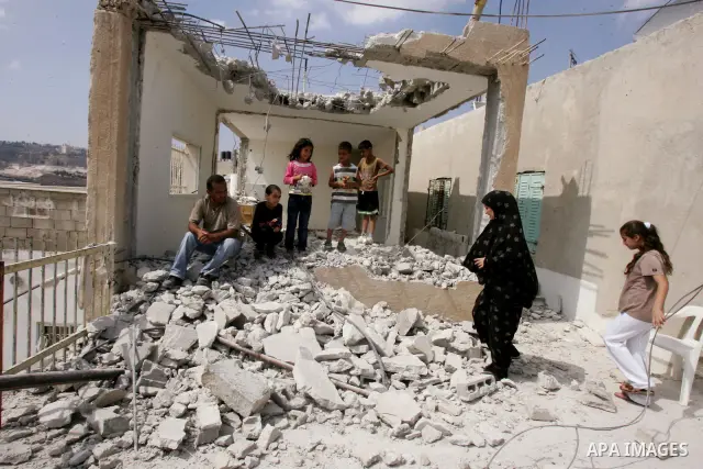 Palestinian Jerusalem resident Adnan Taha destroys his own home with a fellow Palestinian in Arab east Jerusalem on September 11, 2011, in implementation of an Israeli court order which ruled that the house was built wit...