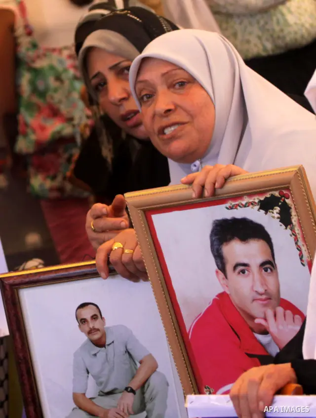 Palestinian women hold pictures of their prisoned relatives in Israeli jails as they gather in a weekly activity calling for their liberty at the Red Cross headquarters in Gaza City on Sep. 12, 2011. About 7000 prisoners...