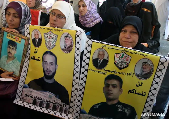 Palestinian women hold pictures of their prisoned relatives in Israeli jails as they gather in a weekly activity calling for their liberty at the Red Cross headquarters in Gaza City on Sep. 12, 2011. About 7000 prisoners...