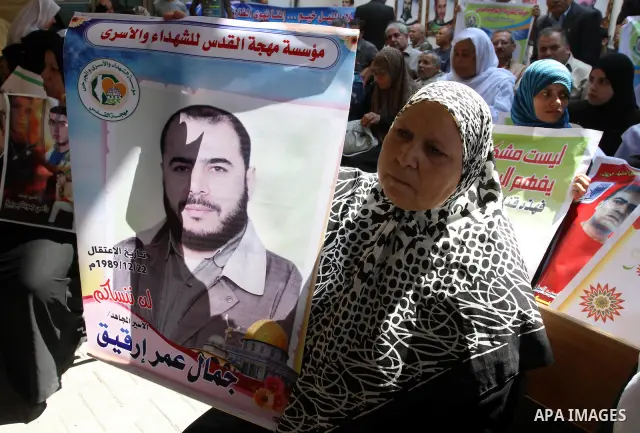 Palestinian women hold pictures of their prisoned relatives in Israeli jails as they gather in a weekly activity calling for their liberty at the Red Cross headquarters in Gaza City on Sep. 12, 2011. About 7000 prisoners...