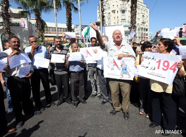 Palestinians hold signs depicting Israel's Prime Minister Benjamin Netanyahu as a pirate during a demonstration supporting the Palestinians' bid for statehood, in the West Bank city of Ramallah, on Sep.12, 2011. The Pale...