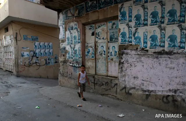 A Palestinians boy walks inside the Jenin refugee camp in the West Bank city of Jenin on Sep. 12, 2011. Photo by Wagdi Eshtayah