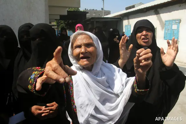 Palestinians shout slogans during a rally supporting a bid for Palestinian statehood recognition at the U.N., at a United Nations Relief and Works Agency (UNRWA) food distribution center in Rafah in the southern Gaza Str...