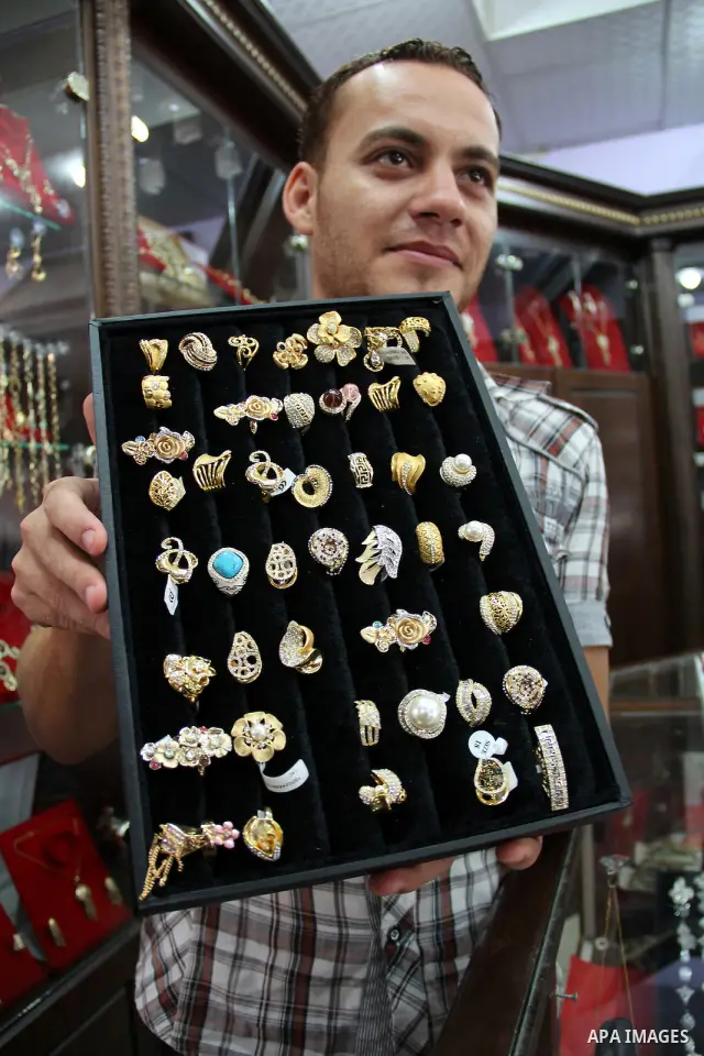 A Palestinian goldsmith displays Chinese jewellery at a jewellery shop in the southern Gaza Strip town of Rafah on September 12, 2011. The price of the Chinese gold is 15 dollars instead of 50 dollars for the other origi...