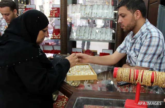 A Palestinian goldsmith displays Chinese jewellery at a jewellery shop in the southern Gaza Strip town of Rafah on September 12, 2011. The price of the Chinese gold is 15 dollars instead of 50 dollars for the other origi...