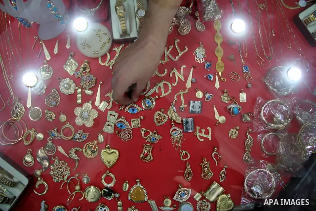 A Palestinian goldsmith displays Chinese jewellery at a jewellery shop in the southern Gaza Strip town of Rafah on September 12, 2011. The price of the Chinese gold is 15 dollars instead of 50 dollars for the other origi...