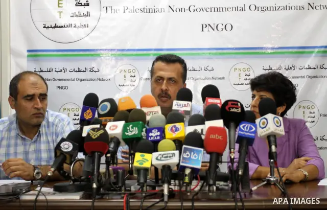 Palestinian members of ?the Network of NGOs delivers speech during a press conference in Gaza city on Sep. 13, 2011. Photo by Mohammed Asad