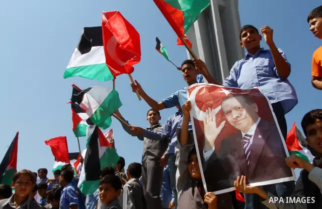 Palestinian students hold the pictures of Turkish Prime Minister Recep Tayyip Erdogan and the Turkish and Palestinian flags during rally beckoning him to visit the Gaza Strip at the port in Gaza City on Sep. 13, 2011. Er...