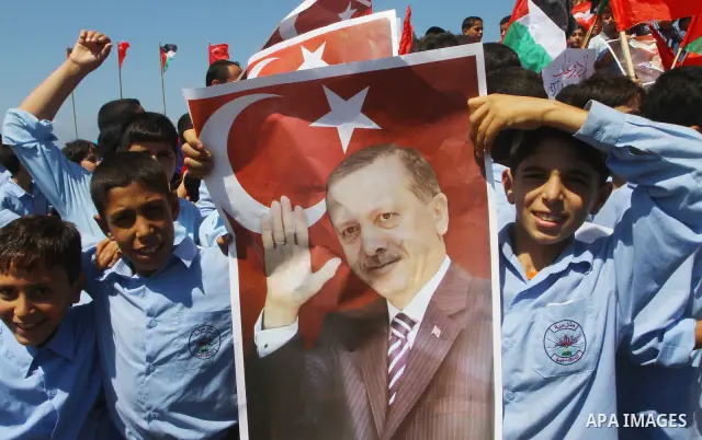 Palestinian students hold the pictures of Turkish Prime Minister Recep Tayyip Erdogan and the Turkish and Palestinian flags during rally beckoning him to visit the Gaza Strip at the port in Gaza City on Sep. 13, 2011. Er...