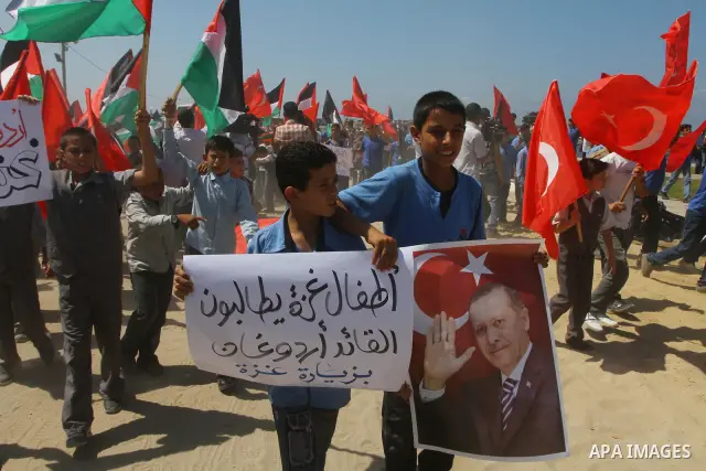 Palestinian students hold the pictures of Turkish Prime Minister Recep Tayyip Erdogan and the Turkish and Palestinian flags during rally beckoning him to visit the Gaza Strip at the port in Gaza City on Sep. 13, 2011. Er...