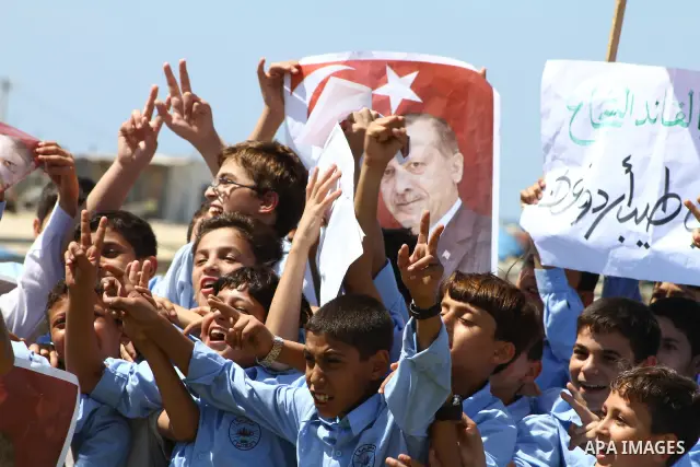 Palestinian students hold the pictures of Turkish Prime Minister Recep Tayyip Erdogan and the Turkish and Palestinian flags during rally beckoning him to visit the Gaza Strip at the port in Gaza City on Sep. 13, 2011. Er...