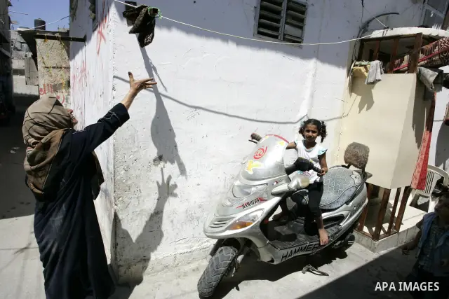 A Palestinian girl sits on Motorcycle in the street in the Rafah Refugee Camp, Southern Gaza Strip on September 13, 2011. A diplomatic showdown looms at the United Nations this month when Palestinian President Mahmoud Ab...
