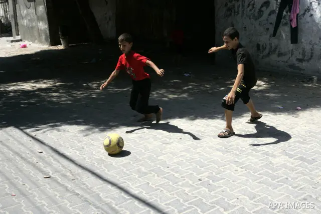 Palestinian children play football in the street in the Rafah Refugee Camp, Southern Gaza Strip on September 13, 2011. A diplomatic showdown looms at the United Nations this month when Palestinian President Mahmoud Abbas...