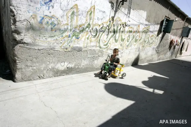 A Palestinian child rides his bicycle in the street in the Rafah Refugee Camp, Southern Gaza Strip on September 13, 2011. A diplomatic showdown looms at the United Nations this month when Palestinian President Mahmoud Ab...