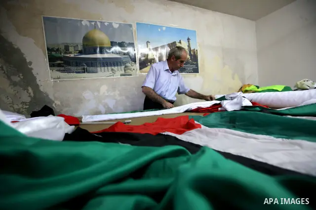 A Palestinian Nabil al-Saed makes Palestinian flags in a factory in the West Bank city of Hebron on 13 September 2011. According to Nabil al-Saed, with the Palestinian push for recognition of statehood at the United Nati...