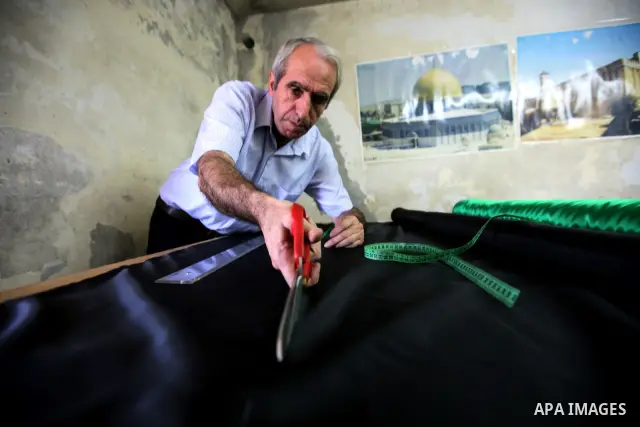 A Palestinian Nabil al-Saed makes Palestinian flags in a factory in the West Bank city of Hebron on 13 September 2011. According to Nabil al-Saed, with the Palestinian push for recognition of statehood at the United Nati...