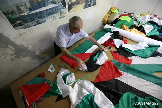 A Palestinian Nabil al-Saed makes Palestinian flags in a factory in the West Bank city of Hebron on 13 September 2011. According to Nabil al-Saed, with the Palestinian push for recognition of statehood at the United Nati...