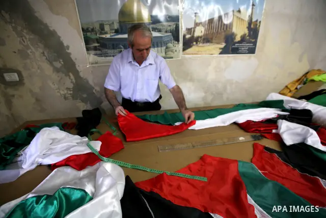A Palestinian Nabil al-Saed makes Palestinian flags in a factory in the West Bank city of Hebron on 13 September 2011. According to Nabil al-Saed, with the Palestinian push for recognition of statehood at the United Nati...
