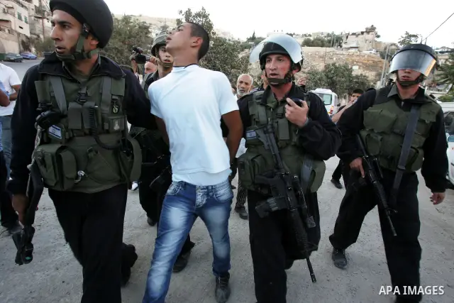 Israeli riot policemen detain a Palestinian youth in the east Jerusalem neighborhood of Silwan on Sep. 13, 2011 following brief clashes between police and Palestinian stone throwers. Photo by Mahfouz Abu Turk