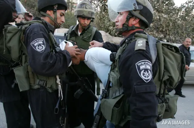 Israeli riot policemen detain a Palestinian youth in the east Jerusalem neighborhood of Silwan on Sep. 13, 2011 following brief clashes between police and Palestinian stone throwers. Photo by Mahfouz Abu Turk