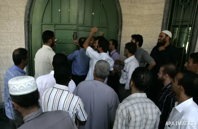 Employees of the Palestinian Authority reject to receive their salaries from the Islamic Bank in Rafah, southern Gaza Strip on Sep. 14, 2011. They explained that this procedure is deducted from the salary of each employe...