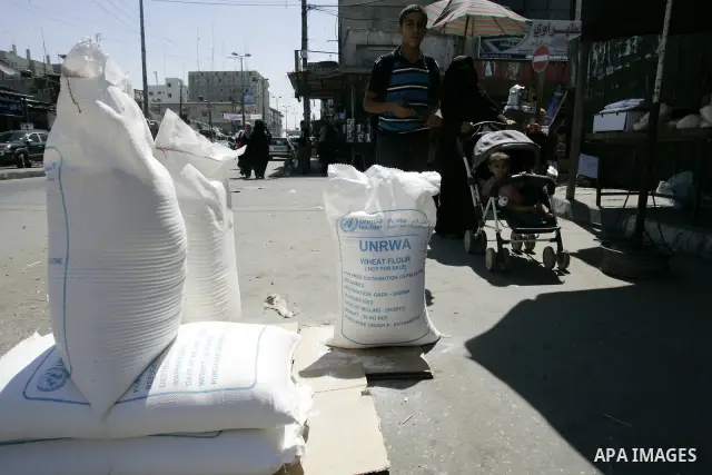 Palestinians receive their food aid from a UN distribution centre in the Rafah refugee camp, southern Gaza Strip on Sep. 14, 2011. Germany provided for the first time a donation to the school's nutrition program, and the...