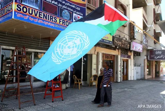A Palestinian and UN flag flutter outside a souvenirs shop in Gaza City as part of the campaign promoting the Palestinians' bid for statehood on September 14, 2011. The Palestinians are preparing to submit a formal reque...