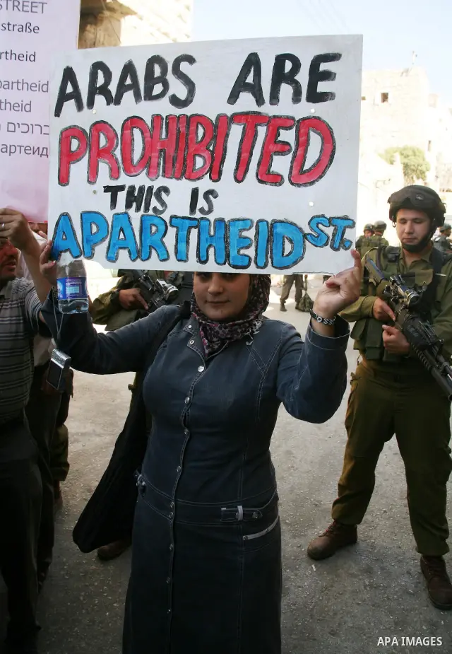 Palestinians take part in a rally against the closure of Shuhada Street in Hebron, the main artery blocked by an Israeli military checkpoint in the center of the West Bank town of Hebron Sep. 14, 2011. Palestinians demon...