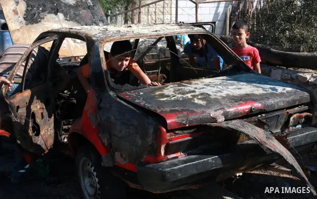 Palestinians inspect a burnt car in the village of Beit Furik, near the West Bank town of Nablus, on Sept. 15, 2011. Vandals set fire to three cars in a West Bank village, and suspicion has fallen on Jewish settlers. Pal...