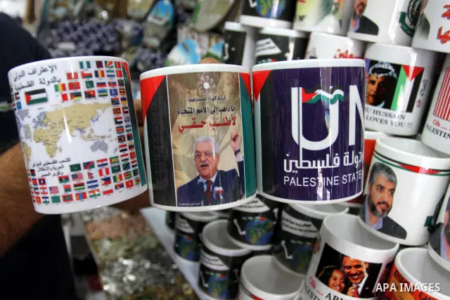 Coffee mugs stand for sale at a souvenirs shop, some of them with a printed picture of the Palestinian President Mahmoud Abbas (Abu Mazen) and others reading 'The world wants the state of Palestine', in Gaza City, on Sep...